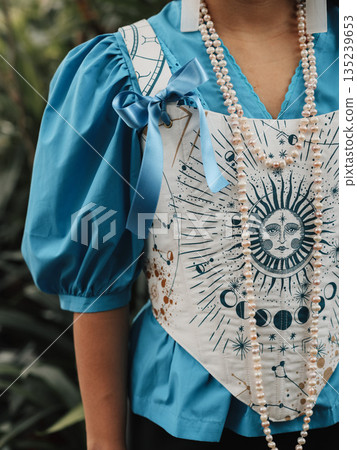 Fashion photograph emphasizing sun motif with jewelry and embroidery Fashion photograph emphasizing sun motif with jewelry and embroidery 135239653