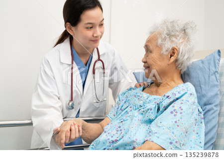 Asian doctor checking and treat elderly woman patient health in hospital. 135239878