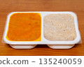 Ready-made dinner dish with rice on a plastic tray. 135240059