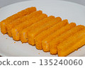 Closeup of fish fillet fingers on white plate. 135240060