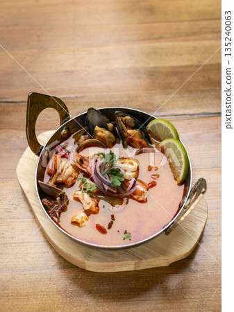 mixed seafood tom yum thai curry soup indoors ina a phuket thailand restaurant mixed seafood tom yum thai curry soup indoors ina a phuket thailand restaurant 135240063