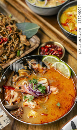 mixed seafood tom yum thai curry soup indoors ina a phuket thailand restaurant 135240064