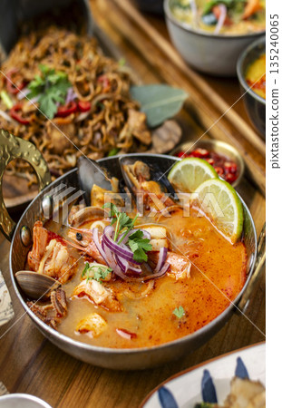 mixed seafood tom yum thai curry soup indoors ina a phuket thailand restaurant mixed seafood tom yum thai curry soup indoors ina a phuket thailand restaurant 135240065