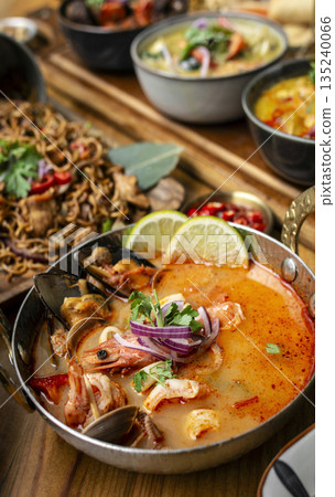 mixed seafood tom yum thai curry soup indoors ina a phuket thailand restaurant mixed seafood tom yum thai curry soup indoors ina a phuket thailand restaurant 135240066