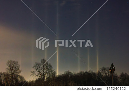 Light Pillars. Rare meteorological phenomena. Winter nature landscape 135240122