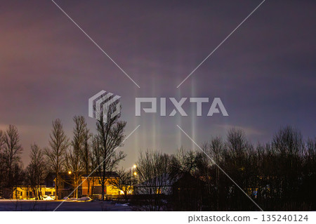 Light Pillars. Rare meteorological phenomena. Winter nature landscape 135240124