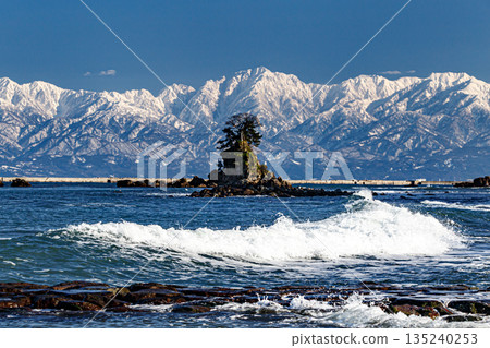 Rough waves at the shore and the Tateyama mountain range 135240253