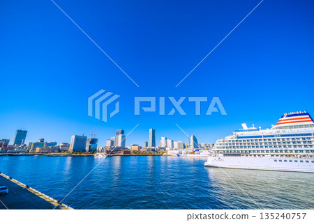Yokohama cityscape in Japan, with Mount Fuji (back center) and Asuka III competing (Nippon Maru at Shinko Pier). Kannai Tower on the left... 135240757