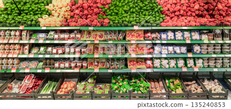 Grocery store. Fresh vegetables and fruits in a colorful showcase. Beautiful fruit and vegetable merchandising. High quality photo 135240853