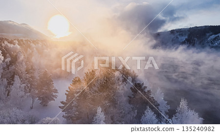 Winter sun rises over snowy Siberian landscape in Krasnoyarsk during New Year celebrations. High quality photo 135240982