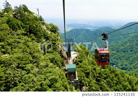 Gozaisho Ropeway: A view of Ise Bay beyond the steel tower and gondolas. Komono Town, Mie County, Mie Prefecture Gozaisho Ropeway: A view of Ise Bay beyond the steel tower and gondolas. Komono Town, Mie County, Mie Prefecture 135241130