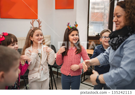 Teacher and elementary students at language school class 135242113