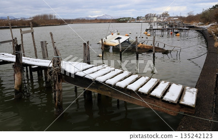 Winter waterway, dock and abandoned ship Winter waterway, dock and abandoned ship 135242123