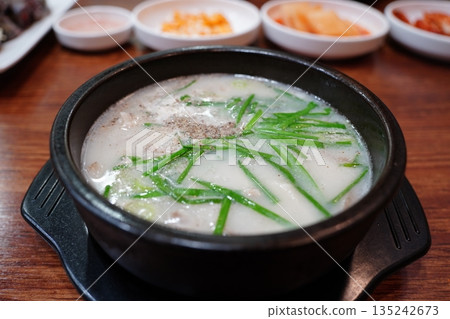 Hearty Korean Sundae-guk (blood sausage soup) with rice in a hot stone pot 135242673