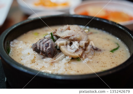 Hearty Korean Sundae-guk (blood sausage soup) with rice in a hot stone pot 135242679