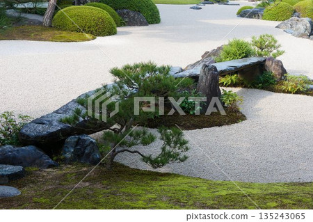 A tranquil garden created by white sand and stones A tranquil garden created by white sand and stones 135243065