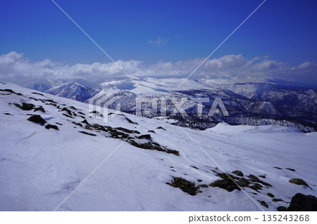 Mount Tomuraushi and the Tokachi mountain range seen from Mount Asahi in winter 135243268
