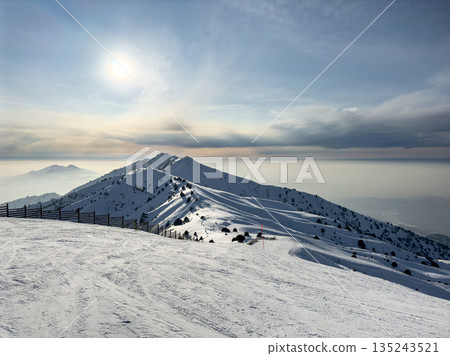 Winter natural landscape. Snow covered mountain peak at Amirsoy ski resort Winter natural landscape. Snow covered mountain peak at Amirsoy ski resort 135243521