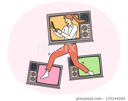 Woman with televisions holds phone showing love for watching online videos in mobile applications 135244394