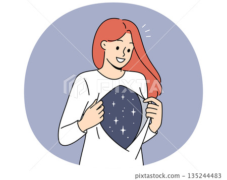 Woman shows depth of soul and inner world with smile, showing stars under shirt. 135244483