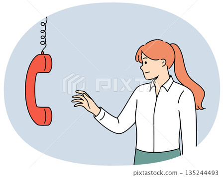 Business woman reaches out to telephone receiver to talk with company partners. 135244493