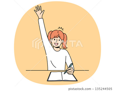 School girl sits at desk with workbook and pen and raises hand wanting to answer teacher question School girl sits at desk with workbook and pen and raises hand wanting to answer teacher question 135244505