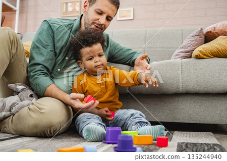 Building memories together in a cozy living room 135244940