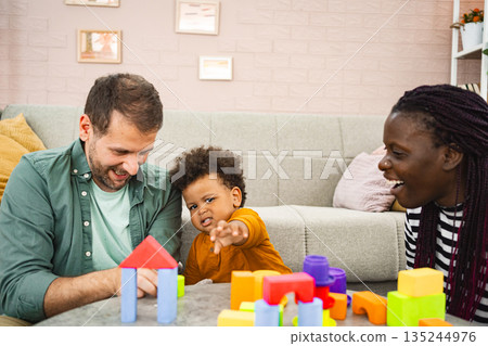 Family bonding during playtime in a cozy living room 135244976