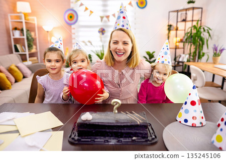 Joyful celebration with children and balloons in a cozy home Joyful celebration with children and balloons in a cozy home 135245106