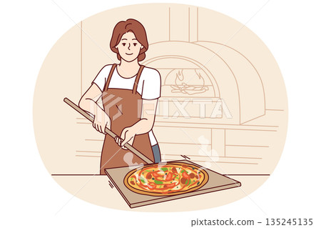Woman is preparing pizza and holding shovel to take out dish from oven for cooking italian food 135245135