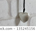 Heart-shaped accessories and brick wall 135245156