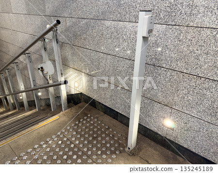 Technologies for disabled people. Pressing button activates wheelchair accessible elevator. Tactile floor tiles indicate hazard ahead for people with disabilities 135245189