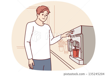Man uses coffee machine standing in kitchen of apartment, preparing drink for invigorating breakfast Man uses coffee machine standing in kitchen of apartment, preparing drink for invigorating breakfast 135245204