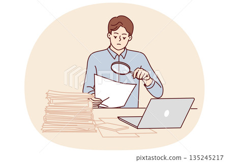 Man tax inspector is sitting in office doing paperwork using magnifying glass to check contract 135245217