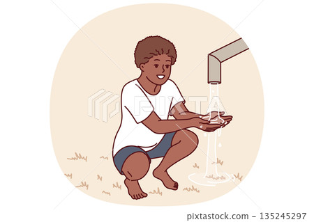 African boy sits near clean water faucet, rejoicing at opportunity to quench thirst during drought 135245297