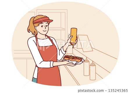 Woman prepares hot dog working as seller in street food cafe or restaurant on wheels Woman prepares hot dog working as seller in street food cafe or restaurant on wheels 135245365