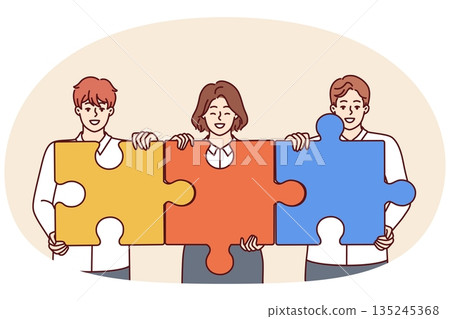 Team businesspeople with puzzles symbolizing teamwork and collaboration to achieve business goals 135245368