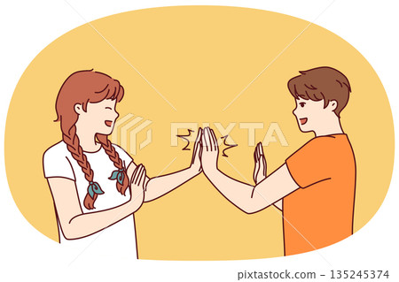 Children play hand-clapping laughing and enjoying teenage friendship and happy childhood 135245374