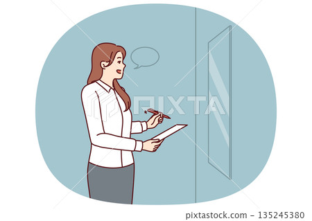 Woman is rehearsing motivational speech standing in front of mirror and learning oratory 135245380