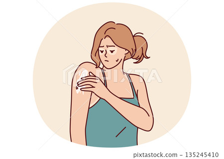 Woman with sunburn applies healing cream on shoulder to repair skin after exposure to ultraviolet Woman with sunburn applies healing cream on shoulder to repair skin after exposure to ultraviolet 135245410