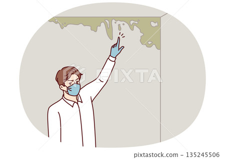 Man near wall with mold and spreading fungus that has arisen due to violation of building codes Man near wall with mold and spreading fungus that has arisen due to violation of building codes 135245506