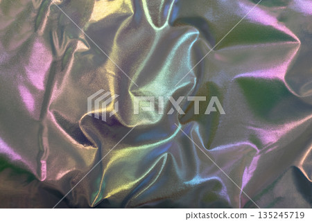 Iridescent fabric texture with colorful folds and shimmering rainbow hues 135245719