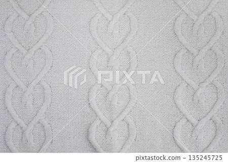 Cozy white knit fabric with a cable pattern and soft texture for a warm home look. Demonstrating color of the year 2026 - cloud and dancer. Cozy white knit fabric with a cable pattern and soft texture for a warm home look. Demonstrating color of the year 2026 - cloud and dancer. 135245725