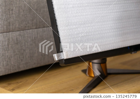 New computer monitor screen covered with white protective packaging, highlighting secure electronics delivery and careful product unboxing New computer monitor screen covered with white protective packaging, highlighting secure electronics delivery and careful product unboxing 135245779