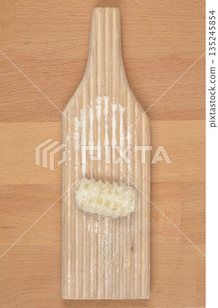 Making Homemade Potato Gnocchi on a Wooden Ridged Board Making Homemade Potato Gnocchi on a Wooden Ridged Board 135245854
