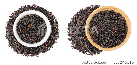 Black wild rice in ceramic and wooden bowl isolated on white background close up. Top view. Flat lay 135246119