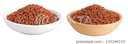 red rice in a ceramic and wooden bowl isolated on white background 135246132