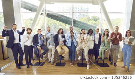 Group of happy diverse business people looking at the camera, smiling and applauding. Group of happy diverse business people looking at the camera, smiling and applauding. 135246236