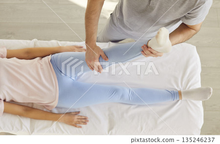 Leg physical therapy, manual rehabilitation, physical therapist doing manipulative massage 135246237