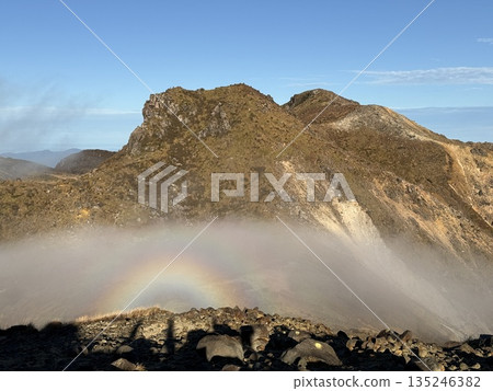 Mountain landscape with a halo caused by the Brocken spectre 135246382